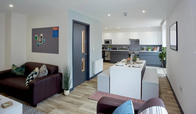 Sofa dining table kitchen and seating area living room at Eden Square in Coventry Student Accommodation