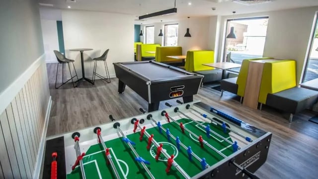 Foosball table pool table booth seating living room at 27 Magdalen Street in Colchester Student Accommodation