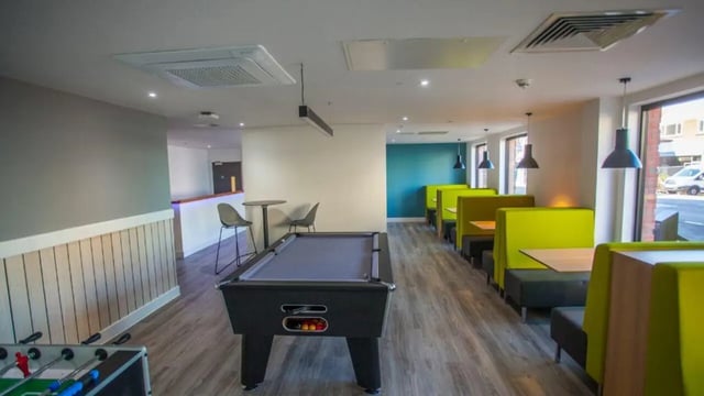 Pool table foosball table booths common area at 27 Magdalen Street in Colchester Student Accommodation