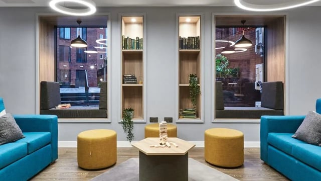 Two blue sofas Jenga table and stools common area at 41 Castle Street in Leicester Student Accommodation