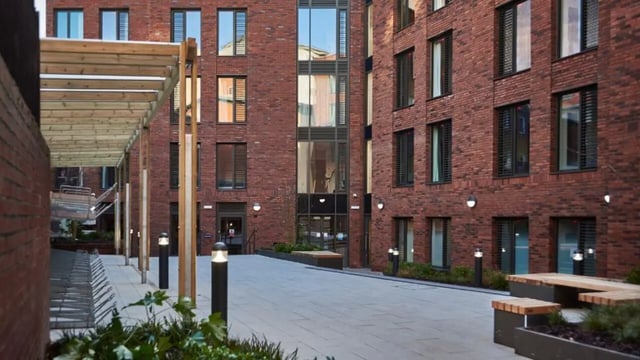 Brick building with courtyard seating exterior at 41 Castle Street in Leicester Student Accommodation