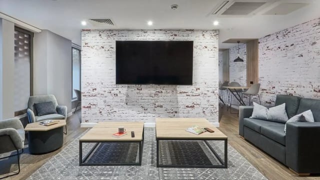 Sofa coffee tables chairs television living room at 41 Castle Street in Leicester Student Accommodation