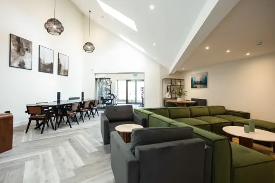 Large sectional sofa and dining table common area at Riverside House - Manchester in Salford Student Accommodation