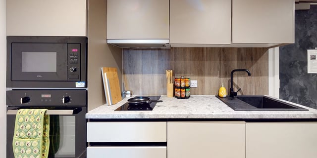 Microwave oven oven chopping boards spice rack sink kitchen at Canvas Manchester in Manchester Student Accommodation