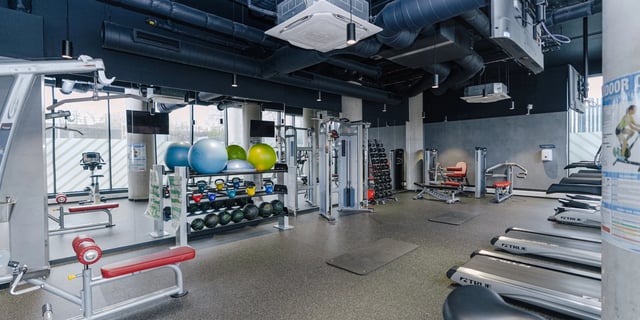 Gym equipment treadmills yoga mats fitness machines fitness room at Canvas Manchester in Manchester Student Accommodation
