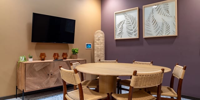 Dining table with chairs and television common area at Canvas Manchester in Manchester Student Accommodation