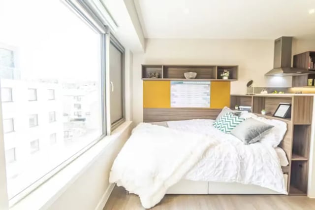 Bed with patterned pillows and blankets bedroom at Brewer's Court in Edinburgh Student Accommodation