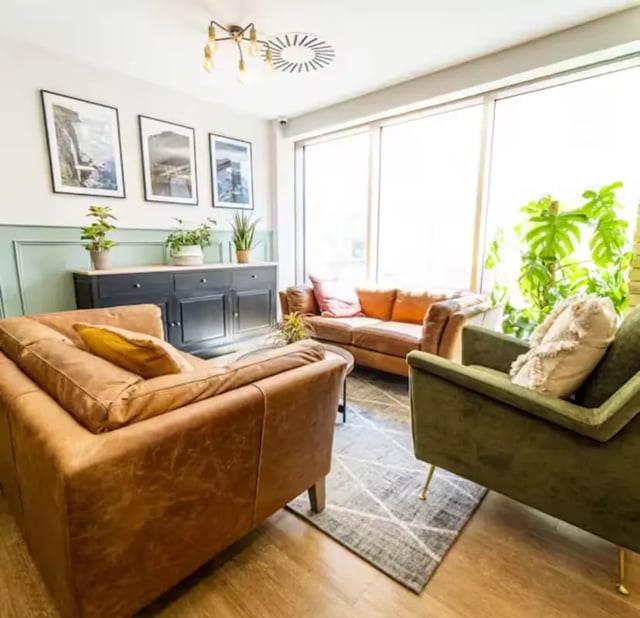 Sofa chairs rug artwork cabinet plants living room at Brewer's Court in Edinburgh Student Accommodation