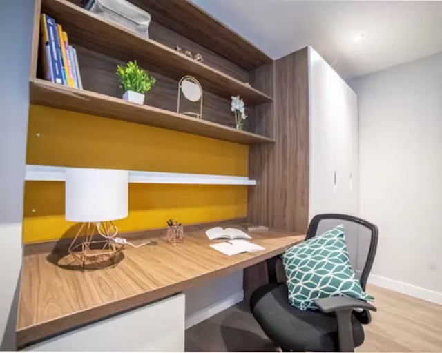 Desk with lamp books pillow and chair study area at Brewer's Court in Edinburgh Student Accommodation