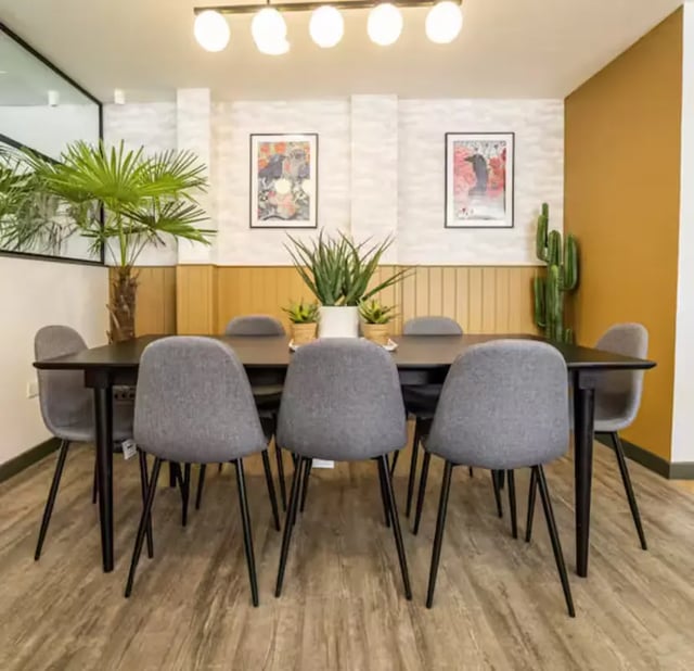 Eight grey chairs around a dark table common area at Brewer's Court in Edinburgh Student Accommodation