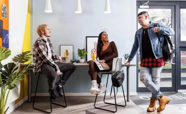 Students talking at desk area living room at Riverside Point in Nottingham Student Accommodation