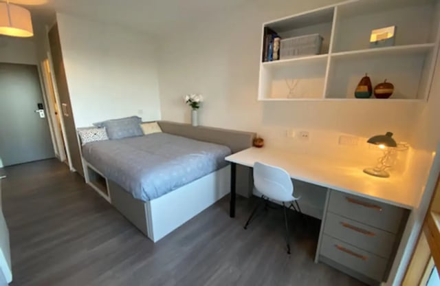 Bed desk chair shelves and lamp bedroom study area at Charles Morton Court in London Student Accommodation