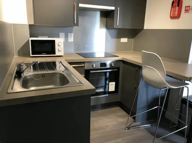 Microwave sink oven stool modern kitchen kitchen at Charles Morton Court in London Student Accommodation