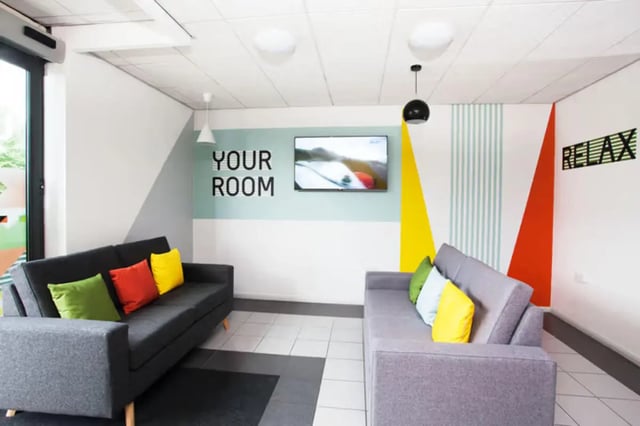 Two sofas wall art TV and modern decor living room at Waterways in Loughborough Student Accommodation