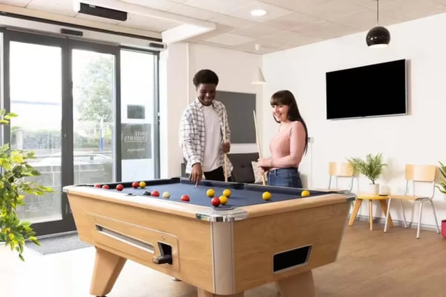 Students playing billiards on pool table living room at Waterways in Loughborough Student Accommodation