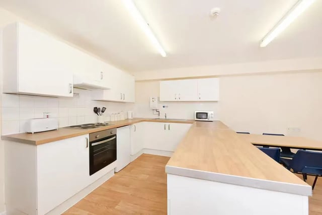 White kitchen cabinets microwave oven and toaster kitchen at Snowdon Hall in Wrexham Student Accommodation