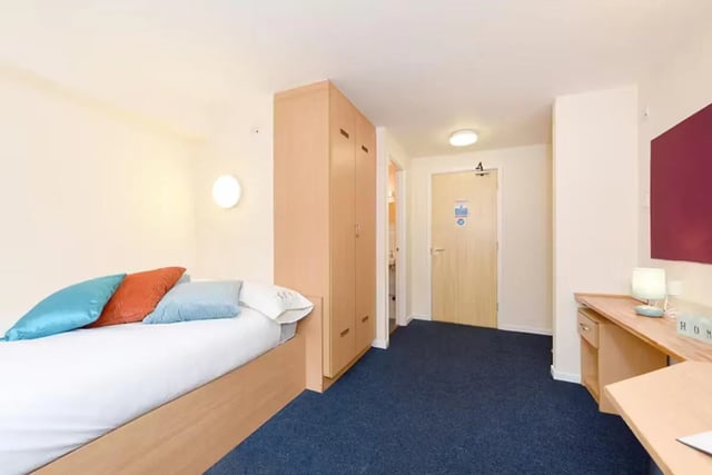 Bed with pillows wardrobe desk and door bedroom at Snowdon Hall in Wrexham Student Accommodation