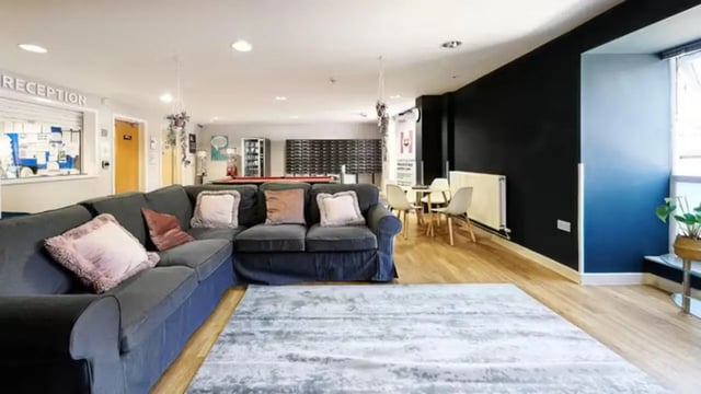 Large sectional couch small tables and chairs common area at The Mews in Oxford Student Accommodation