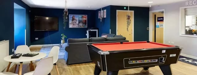 Pool table sofa television chessboard game area at The Mews in Oxford Student Accommodation
