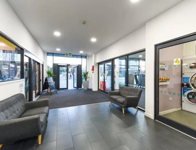 Two sofas plants and washing machines common area at Nottingham Two in Nottingham Student Accommodation