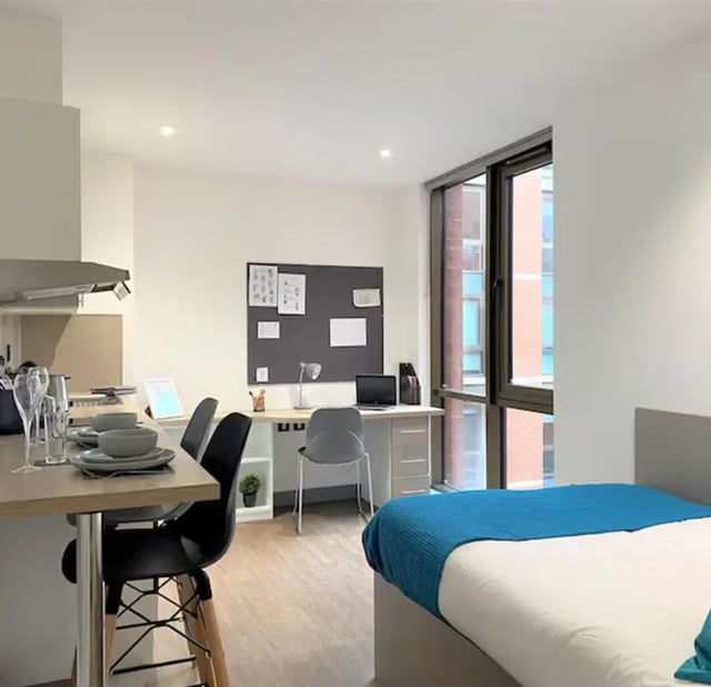 Table desk bed and kitchen area studio at Nottingham Two in Nottingham Student Accommodation