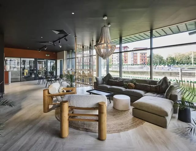 Modern lounge with sectional sofa and chairs Living room at Nottingham Two in Nottingham Student Accommodation