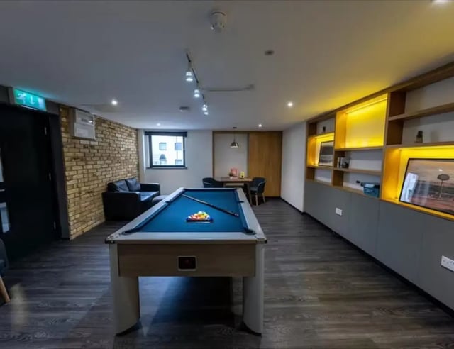 Pool table sofa shelves and chairs common area at Trinity Square in Nottingham Student Accommodation
