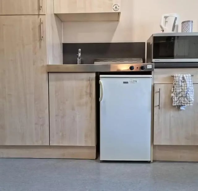 Compact kitchen with fridge microwave stove kitchen at Trinity Square in Nottingham Student Accommodation