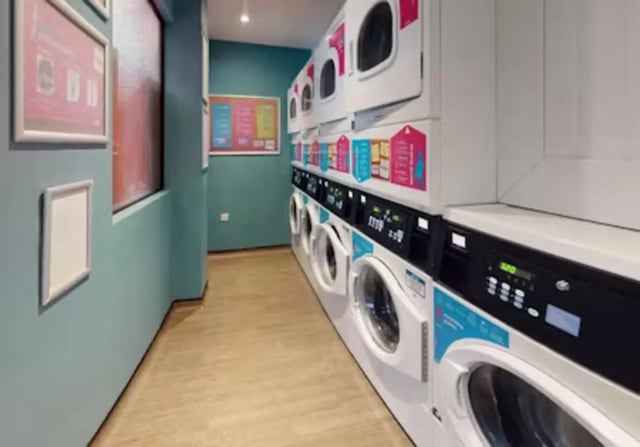 Stacked washing machines and dryers laundry area at iQ Twerton Mill in Bath Student Accommodation
