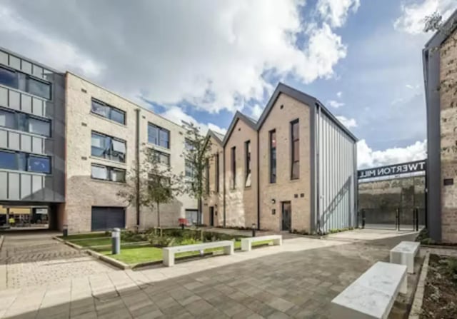 Modern buildings with benches and greenery exterior at iQ Twerton Mill in Bath Student Accommodation