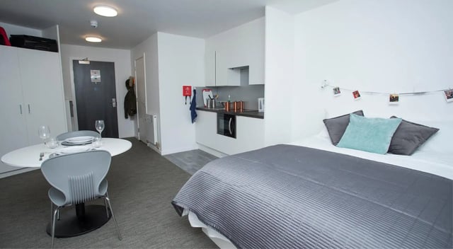 Bed kitchen dining table with chairs studio apartment at Fraser Studios in Aberdeen Student Accommodation