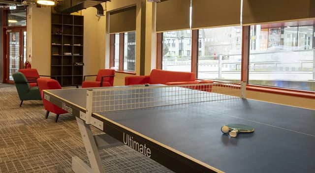 Ping pong table chairs and bookshelf communal room at Fraser Studios in Aberdeen Student Accommodation