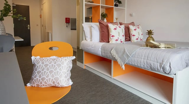 Bed with flamingo pillows and gold tray Bedroom at Fraser Studios in Aberdeen Student Accommodation