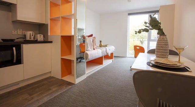 Kitchen bed desk with orange chair study area living room at Fraser Studios in Aberdeen Student Accommodation