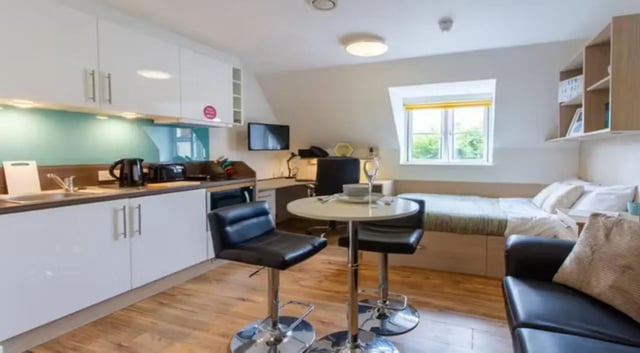Kitchen bed desk table chair sofa living room at Iron Bridge Studios in Exeter Student Accommodation