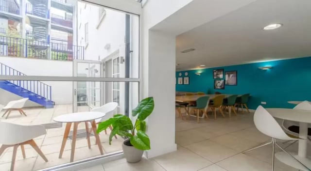 Tables chairs patio and communal dining area at Iron Bridge Studios in Exeter Student Accommodation