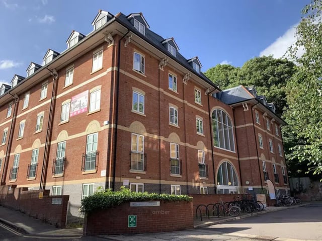 Red brick student accommodation building with bicycles exterior at Iron Bridge Studios in Exeter Student Accommodation