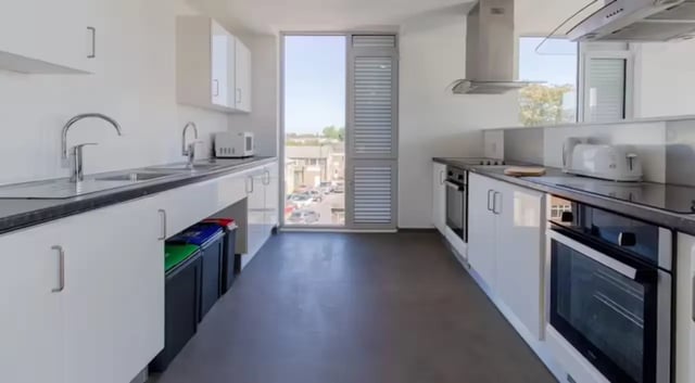 White cabinets sinks toaster ovens recycling bins kitchen at The Union Leamington in Leamington Spa Student Accommodation