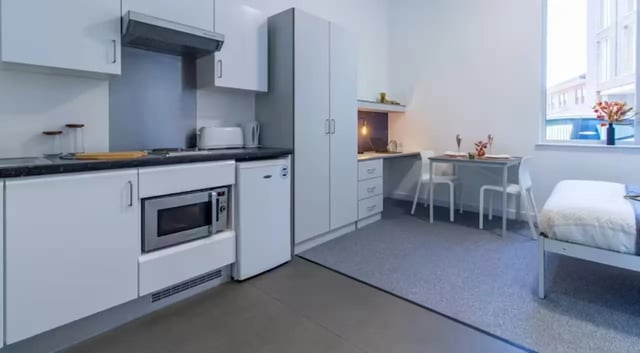 Kitchen desk table bed and chairs living room at The Union Leamington in Leamington Spa Student Accommodation