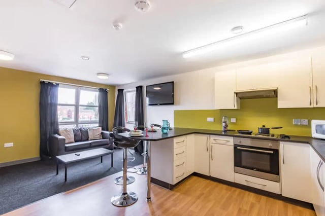 Sofa coffee table bar stools kitchen units oven living room kitchen at Russell View in Nottingham Student Accommodation