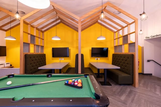 Pool table booths televisions and yellow walls communal area at Bailey Street in Sheffield Student Accommodation