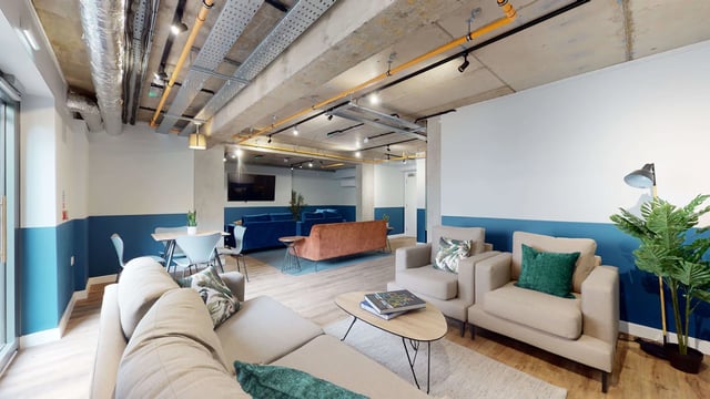 Sofas chairs tables and plant living area at Mayfield Residences in Edinburgh Student Accommodation