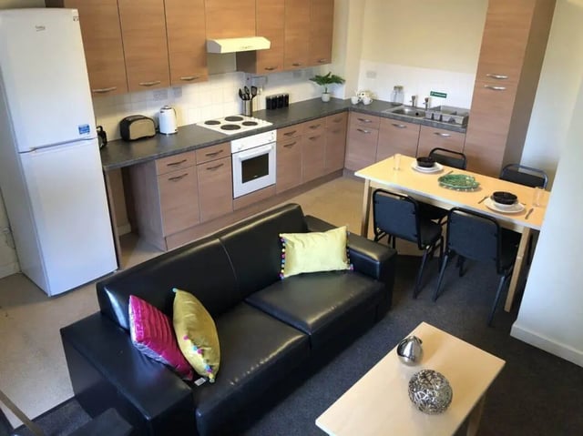 Kitchen with sofa dining table and appliances living room at Horton House Bradford in Bradford Student Accommodation