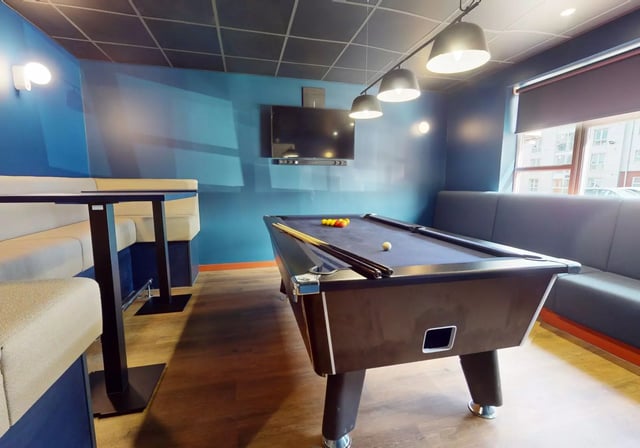 Pool table sofa booth and TV living room at iQ Student Quarter in Salford Student Accommodation