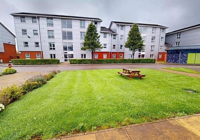 Accommodation buildings with picnic table and lawn exterior at iQ Student Quarter in Salford Student Accommodation