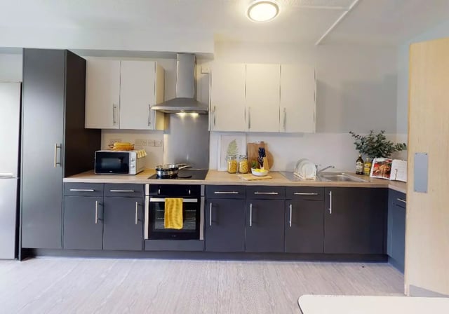 Modern kitchen with microwave oven stovetop sink kitchen at iQ Student Quarter in Salford Student Accommodation