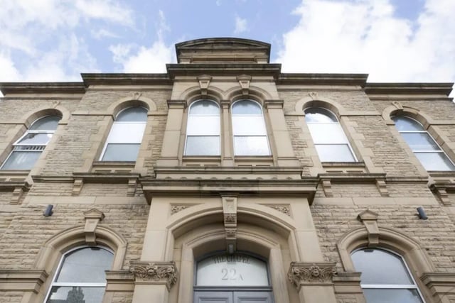 Stone building facade with arched windows exterior at The Old Chapel in Huddersfield Student Accommodation