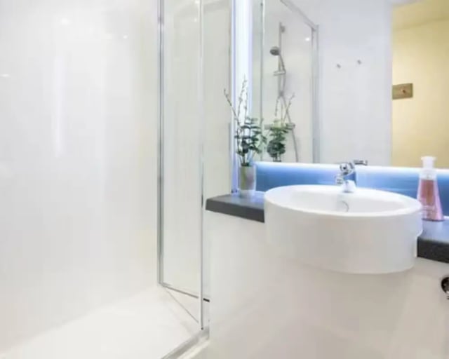 White sink shower enclosure and mirror bathroom at Hollis Croft in Sheffield Student Accommodation
