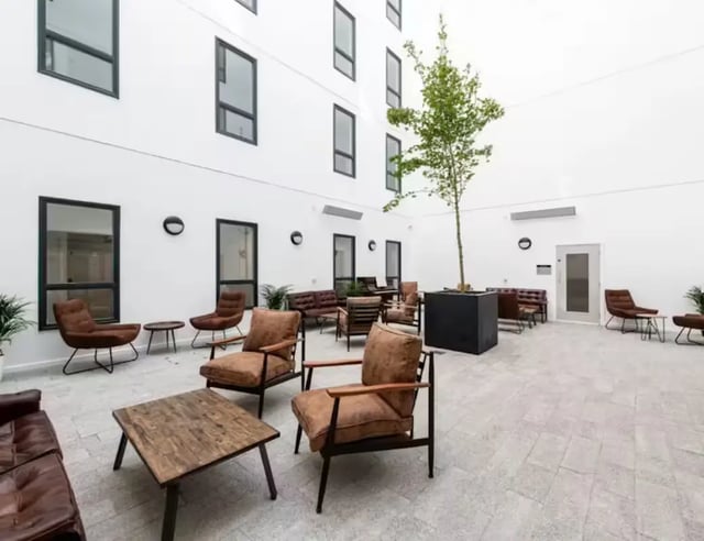 Courtyard seating with tree and lounge area at Hollis Croft in Sheffield Student Accommodation
