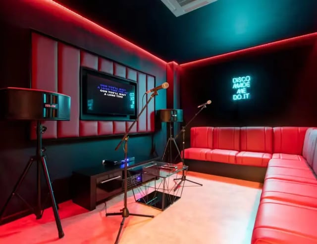 Microphones television red sofa neon sign lounge area at Hollis Croft in Sheffield Student Accommodation